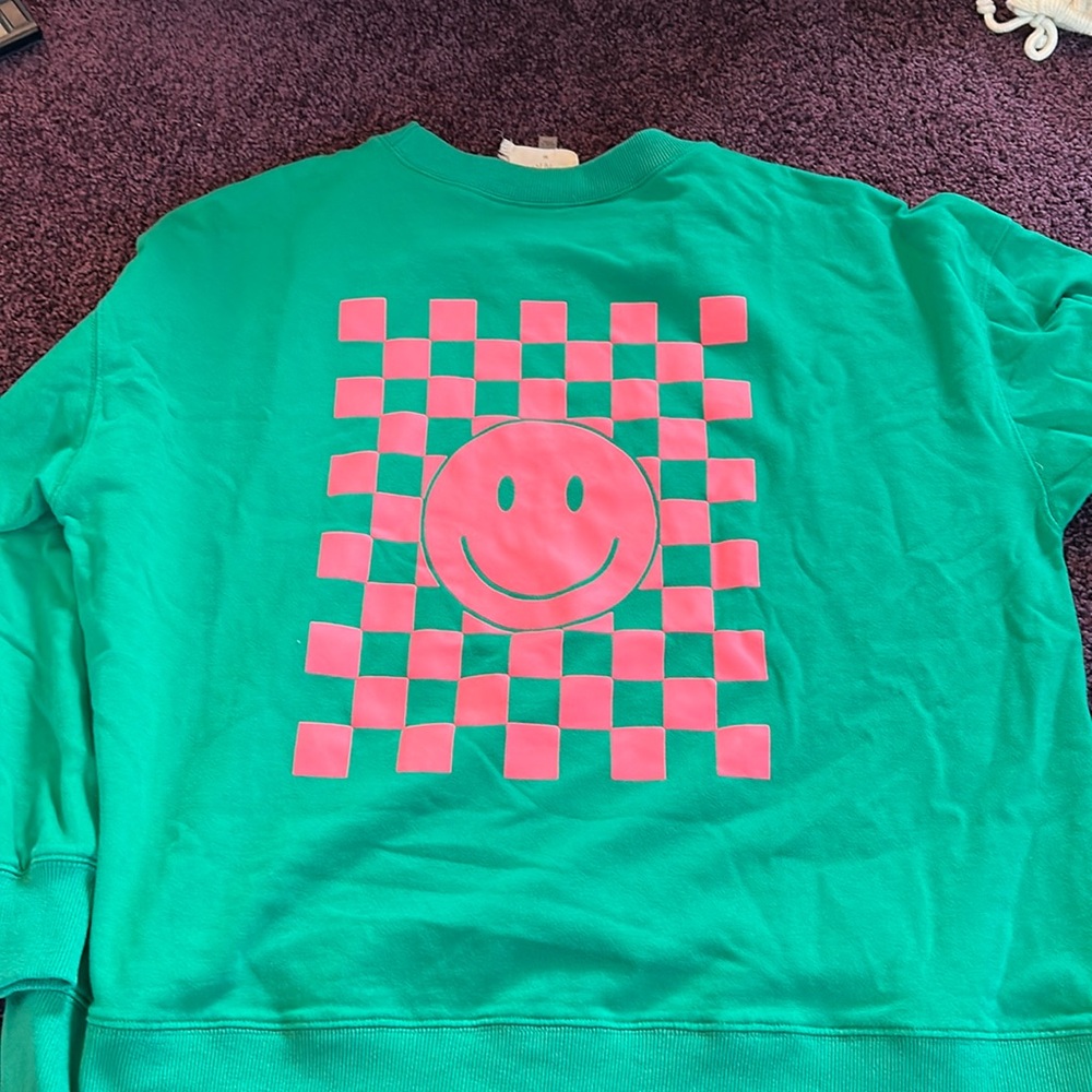 Super cute green and pink smiley checkered sweatshirt. Perfect for teaching